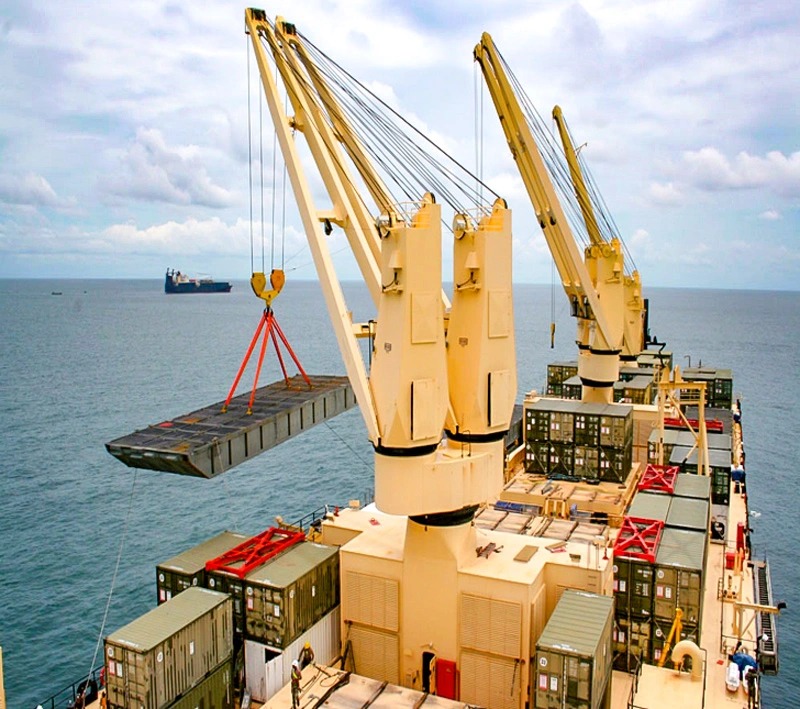 Ship deck crane lifting operation offshore, showing controlled hoisting and safe load handling on a working deck.